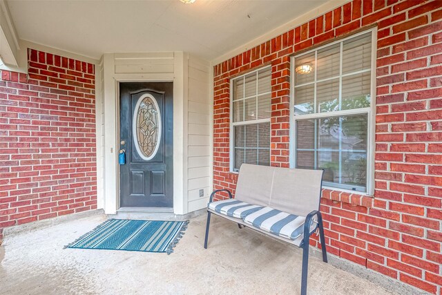 view of exterior entry with covered porch