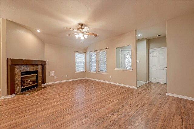 unfurnished living room featuring recessed lighting, a tiled fireplace, light wood-style floors, a ceiling fan, and baseboards