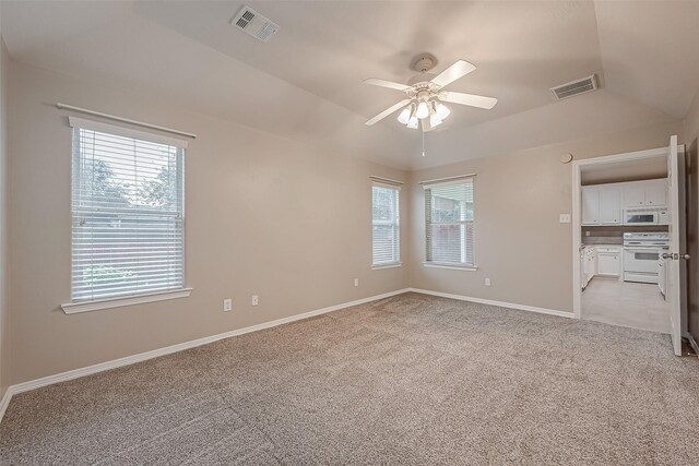 unfurnished bedroom featuring light carpet, baseboards, visible vents, and ceiling fan