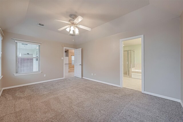 unfurnished bedroom with baseboards, visible vents, ensuite bathroom, and light colored carpet