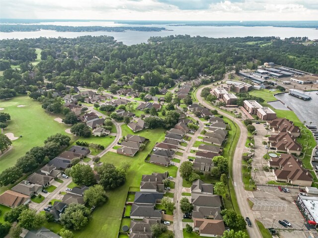 drone / aerial view featuring a water view and a residential view