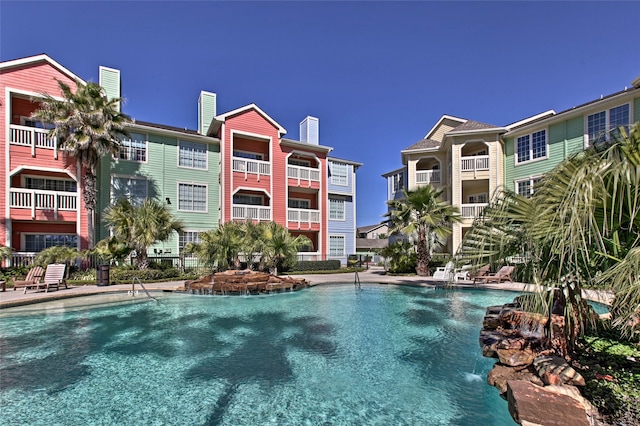 view of swimming pool with pool water feature