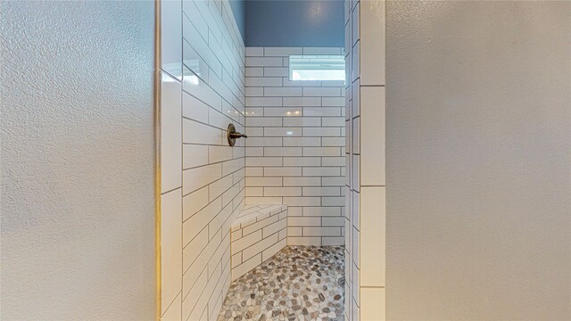 bathroom featuring a tile shower