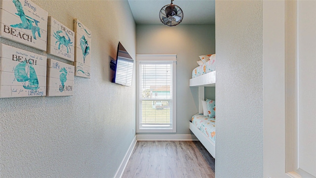 bedroom featuring multiple windows and hardwood / wood-style floors