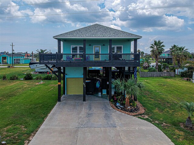 exterior space featuring a garage, a front lawn, covered porch, and a carport