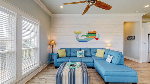 living room featuring ceiling fan, light hardwood / wood-style flooring, and a healthy amount of sunlight