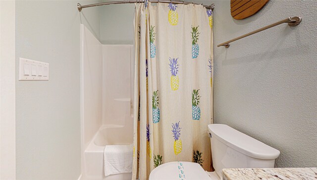 bathroom featuring shower / bathtub combination with curtain and toilet