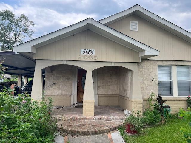 entrance to property featuring a carport