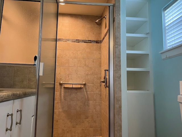 bathroom with vanity and a shower with shower door