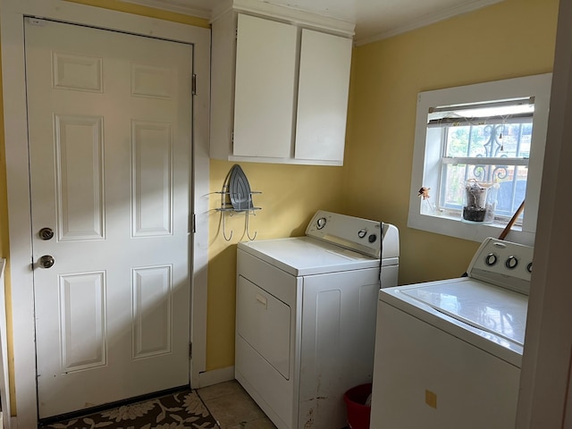 washroom featuring washer and dryer, cabinets, and crown molding