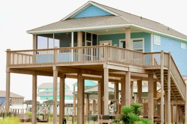 rear view of house featuring a wooden deck