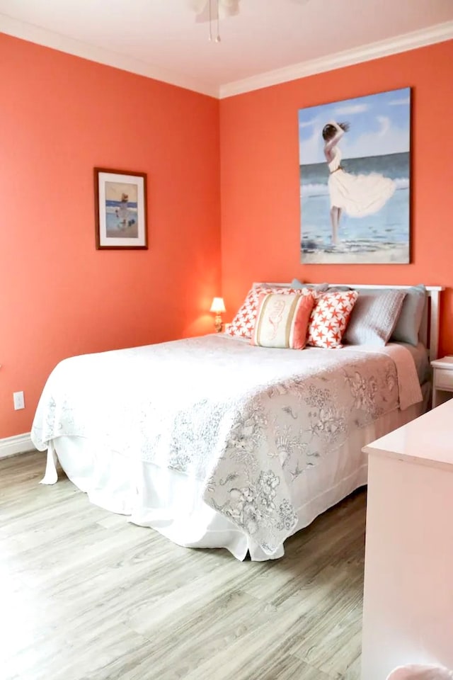 bedroom with crown molding and hardwood / wood-style flooring