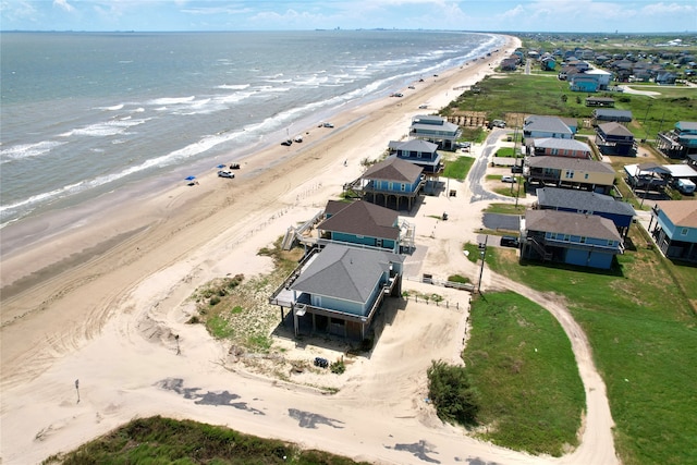 bird's eye view featuring a water view and a beach view