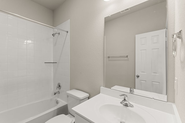 full bathroom featuring a textured wall, toilet, bathing tub / shower combination, vanity, and visible vents