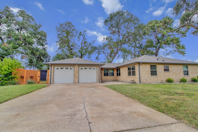 single story home featuring a garage and a front lawn