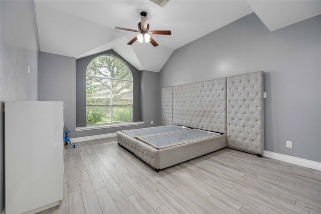 unfurnished bedroom with lofted ceiling, ceiling fan, and light hardwood / wood-style floors