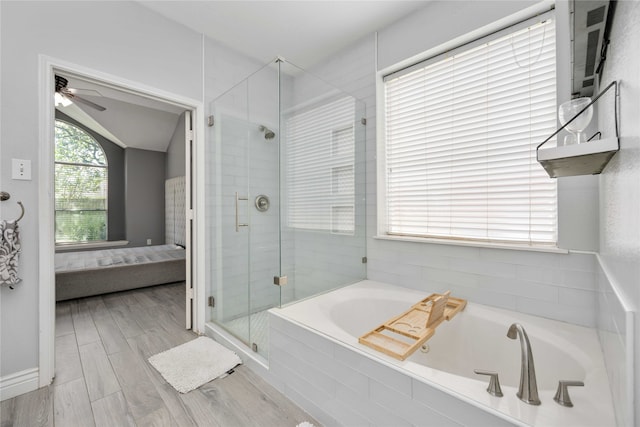 bathroom with vaulted ceiling, ceiling fan, wood-type flooring, and plus walk in shower