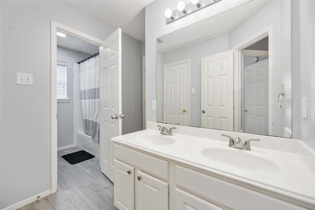 bathroom with vanity, wood-type flooring, and shower / bathtub combination with curtain