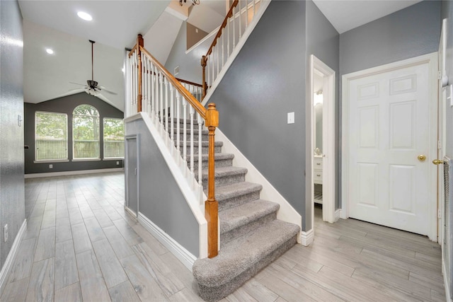 foyer with vaulted ceiling, ceiling fan, and light hardwood / wood-style flooring