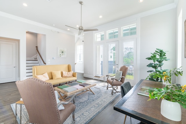 living room featuring crown molding, dark wood-type flooring, and ceiling fan