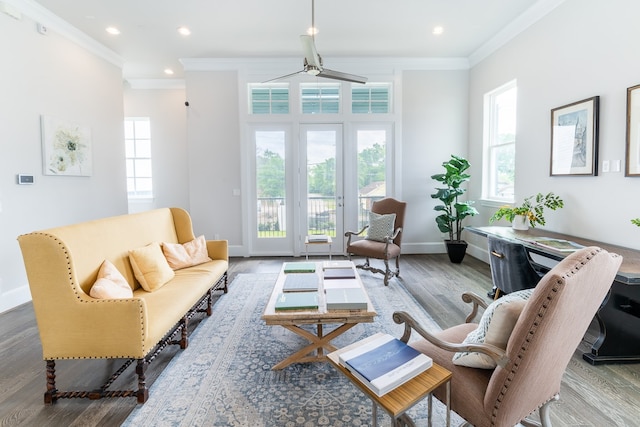 living room with ornamental molding, hardwood / wood-style floors, and ceiling fan