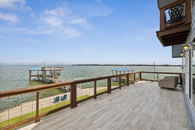 view of dock featuring a balcony and a water view