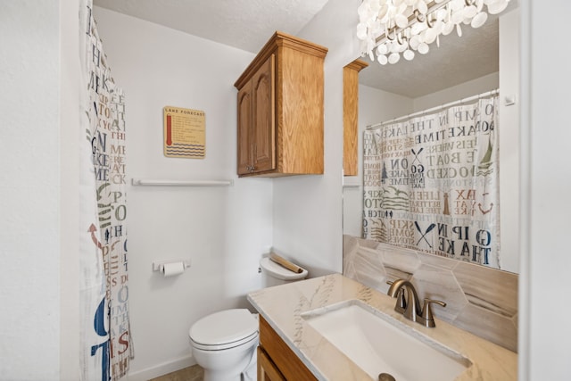 bathroom with vanity, toilet, a shower with curtain, and a textured ceiling