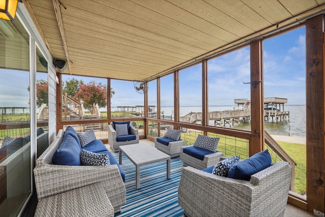 sunroom / solarium featuring a water view and wood ceiling