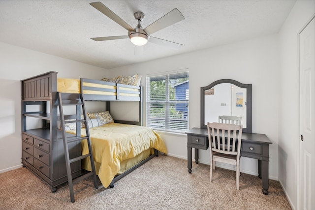 carpeted bedroom with a textured ceiling and ceiling fan