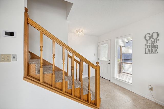 stairway featuring tile patterned flooring