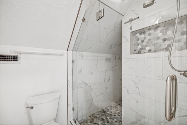 bathroom with toilet and a shower with shower door