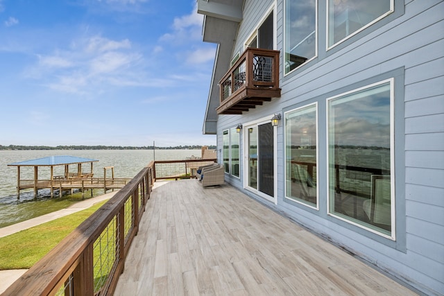 wooden terrace featuring a water view