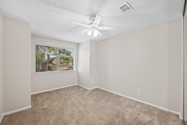 empty room with a textured ceiling, ceiling fan, and carpet flooring