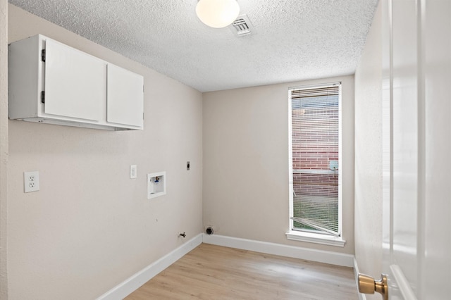 washroom with cabinets, a healthy amount of sunlight, hookup for a washing machine, and electric dryer hookup