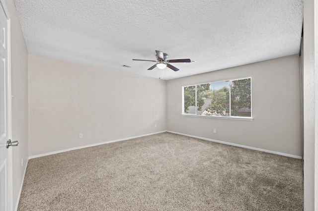 carpeted empty room featuring a textured ceiling and ceiling fan