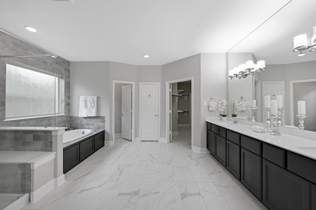 bathroom with vanity and independent shower and bath