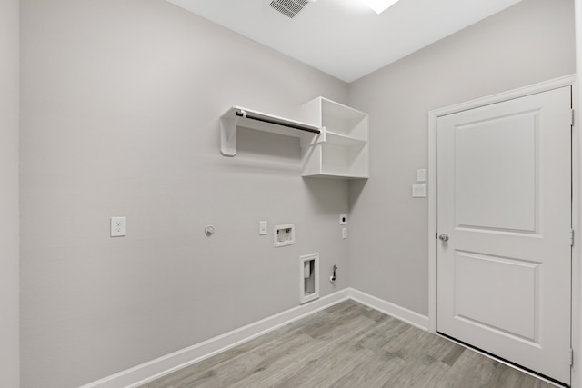 washroom with hookup for an electric dryer, washer hookup, light hardwood / wood-style floors, and gas dryer hookup