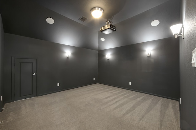 carpeted empty room featuring lofted ceiling