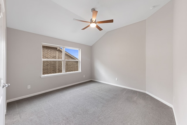 empty room featuring ceiling fan, carpet, and lofted ceiling