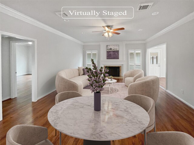 living room featuring ceiling fan, plenty of natural light, dark hardwood / wood-style flooring, and crown molding