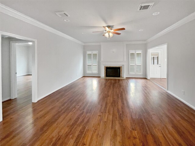 unfurnished living room featuring ceiling fan, ornamental molding, and dark hardwood / wood-style flooring