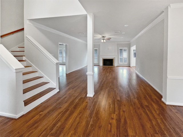 unfurnished living room featuring crown molding, dark hardwood / wood-style flooring, and ceiling fan