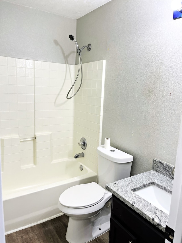 full bathroom with shower / bathing tub combination, a textured ceiling, hardwood / wood-style flooring, toilet, and vanity