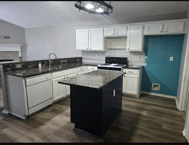 kitchen with black gas stove, white cabinets, dishwasher, and vaulted ceiling