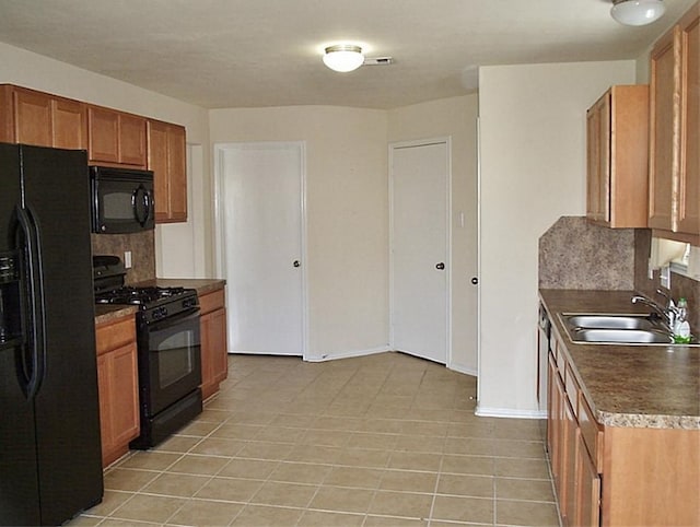 kitchen with black appliances, light tile patterned flooring, sink, and tasteful backsplash