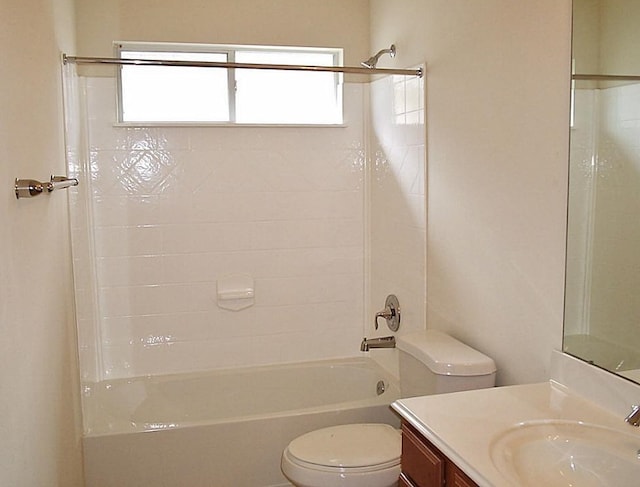 full bathroom featuring tiled shower / bath, toilet, and vanity