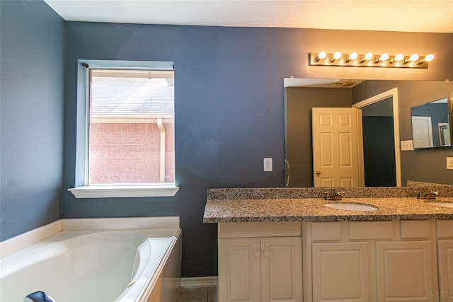 bathroom with vanity and a bath