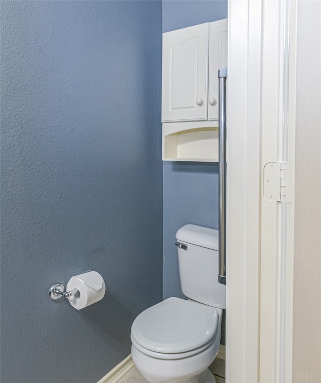 bathroom featuring toilet and tile patterned floors