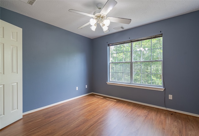 unfurnished room featuring a textured ceiling, hardwood / wood-style flooring, and ceiling fan