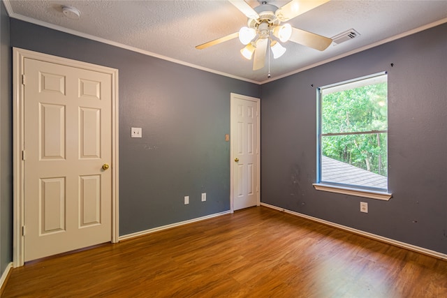 unfurnished room with ceiling fan, crown molding, a textured ceiling, and hardwood / wood-style floors